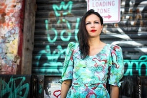 woman outside with graffiti