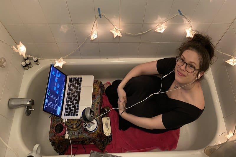 Ali Darling in a bathtub with a laptop
