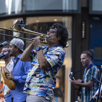 Man Playing Trombone with a band