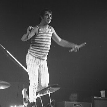 Keith Moon standing on drum kit