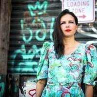 woman outside with graffiti